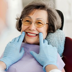 Dentist looking at smiling patient's teeth