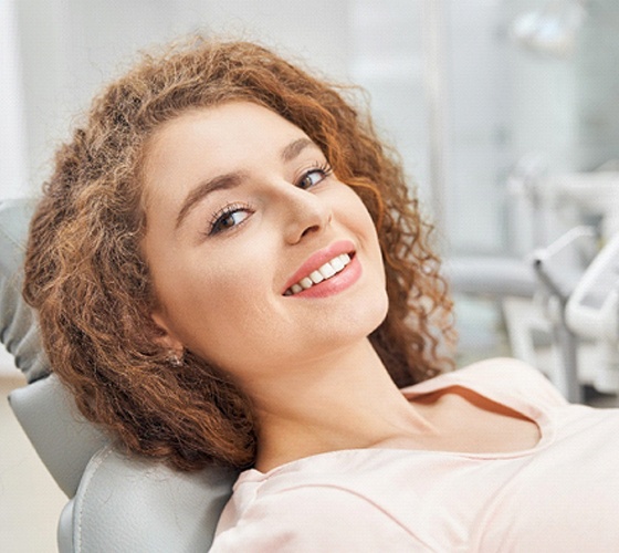 Woman sitting back in chair for dental implants in Lady Lake, FL