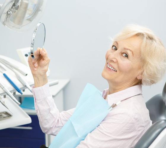 woman learning who is a good candidate for All-On-4 dental implants in Lady Lake