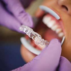 Dentist in Lady Lake placing Invisalign on patient