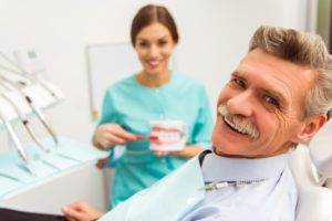 Smiling man who just got implant dentures in Lady Lake