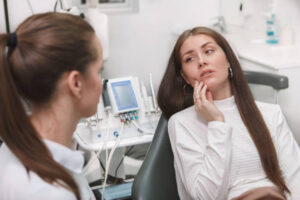 Woman with a toothache at emergency dentist